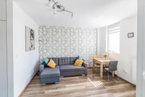 a living room with a couch and a table at Star4You Apartments in Wrocław