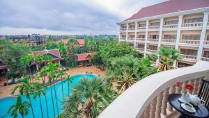 an aerial view of a hotel with a pool and palm trees at Borei Angkor Resort & Spa in Siem Reap