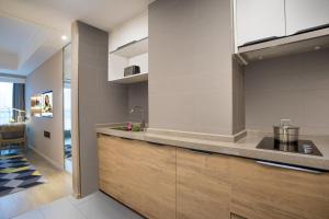 a kitchen with a sink and a counter top at Citadines Keqiao Shaoxing in Shaoxing