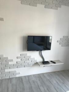a tv in a wall with a brick wall at 71 Cafe B&B in Kaohsiung