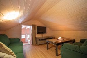 a living room with a couch and a table at Cabin in Hodlekve with 5 bedrooms & hot tub. in Sogndal
