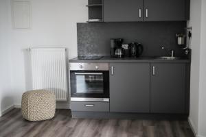 a kitchen with a stove and a chair in a room at TalBlick in Winterberg