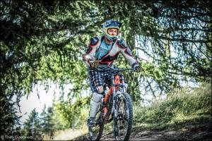 a man riding a bike down a dirt road at Hôtel Bel'Air in Jausiers