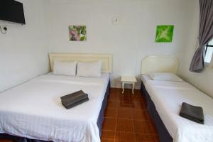 A bed or beds in a room at Vagary Pangkor