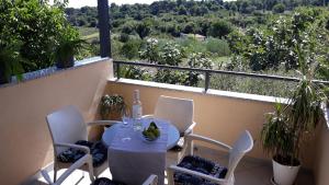 a table and chairs on a balcony with a view at Apartment Piranesi with a parking space in Pula