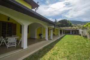 a patio of a house with a table and chairs at Villa Pina in LʼAquila