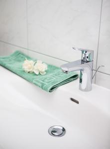 a bathroom sink with a mirror and a towel at Pension Charly in Sölden