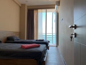 a hotel room with two beds and a balcony at Gonio Beachfront Panorama in Gonio