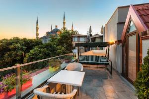 a patio area with a patio table and chairs at Obelisk Hotel & Suites in Istanbul