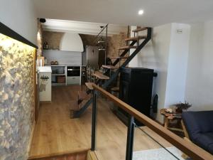 a staircase leading to a living room and a kitchen at Can Puig de la Pera in La Pera