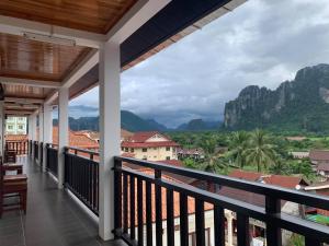 a balcony with a view of the mountains at Jasmine Vangvieng Hotel in Vang Vieng