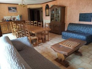 a living room with a couch and a table at gite de la fontaine in Épothémont