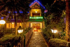 a building with a sign that reads chianti greek restaurant at night at Hotel Nahar Nilgiris in Ooty
