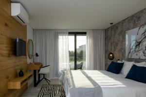 a hotel room with a large bed and a window at Central Beach Villas in Cape Town