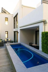 a swimming pool in the backyard of a house at Central Beach Villas in Cape Town