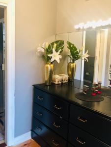 a dresser with two vases on it with a mirror at Stunning house with beautiful entertainment area!! in Marion