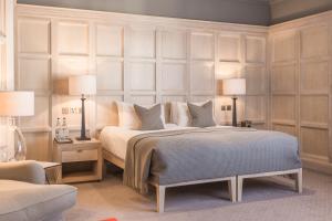 a bedroom with a large bed with two lamps at The Scotsman Hotel in Edinburgh