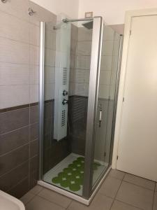a shower with a glass door in a bathroom at Le Miromí in Civitanova Marche