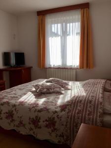 a bedroom with a bed with a blanket on it at Farm Stay Pri Cepčovih in Golac