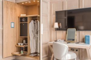 a room with a desk with a computer and a television at The Scotsman Hotel in Edinburgh
