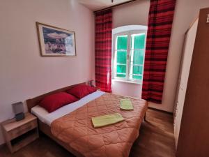 a bedroom with a bed and a window at Big and Spacious Apartment in the heart of Omi&scaron; in Omi&scaron;