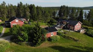 an aerial view of a house in a field at Puolukkamaan Pirtit Cottages in Lampsijärvi