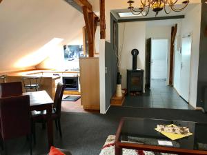 a living room with a table and a kitchen at Historic Apartments in Bremen-Vegesack