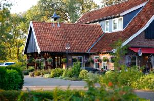 a house with a roof with a bird on top of it at Het Ros van Twente in De Lutte