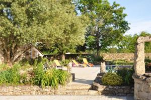 a garden with chairs and trees in the background at Chambre d'hôtes Sauternais in Pujols-sur-Ciron