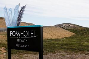 a sign for a fox hotel with a hill in the background at Fosshótel Mývatn in Myvatn