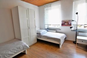 a bedroom with two beds and a window at Central Apartment Bergisch Gladbach in Bergisch Gladbach