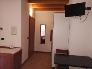 a room with a desk and a television on the wall at Ca' Del Sasso in Verona