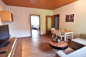 a living room with a table and a dining room at Central Apartment Bergisch Gladbach in Bergisch Gladbach