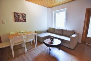 a living room with a couch and a table at Central Apartment Bergisch Gladbach in Bergisch Gladbach