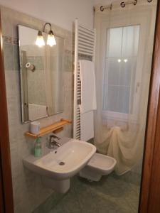 a bathroom with a sink and a toilet and a mirror at Ca' Del Sasso in Verona +31 photos