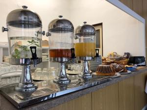 a kitchen counter with two glass containers filled with liquid at Penzion Nový mlýn in Staré Splavy
