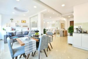 a living room with a couch and a table and chairs at AEOLIS SUITES in Athens