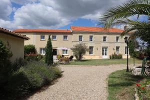 a large building with a dog sitting in front of it at Domaine des Tilleuls in Marcillac