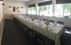 uma longa sala de jantar com uma longa mesa e cadeiras em Hotel Rødding em Rødding