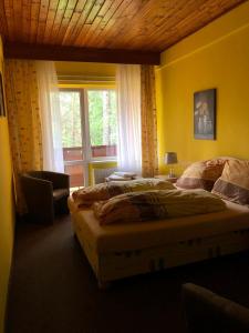a bedroom with two beds and a window at Penzion Nový mlýn in Staré Splavy