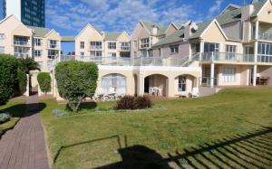 a large apartment building with a green lawn at Summerseas 56 in Port Elizabeth