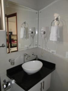 a bathroom with a white sink and a mirror at Hotel Campestre Villa Juliana in Chía