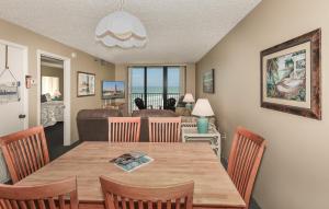 a dining room with a wooden table and chairs at Ocean Trillium Suites in New Smyrna Beach