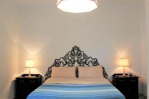 a bedroom with a bed with two night stands and two lamps at Sun Terrace Sorrento in Sorrento