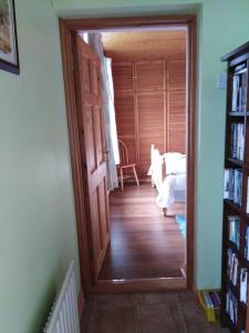 a hallway with an open door to a bedroom at Catherine's Lair A Quiet peaceful Homestay in Westport