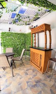 a patio with a table and chairs and a wooden table and a table and chairs at Casa con alberca climatizada privada para 8 personas in Emiliano Zapata