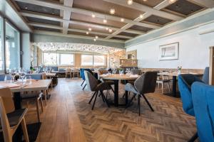 a restaurant with wooden floors and tables and chairs at Landhotel Bodensee in Konstanz