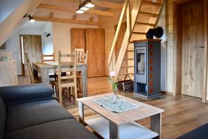 a living room with a couch and a table at Penzion Beskydkrby in Ostravice