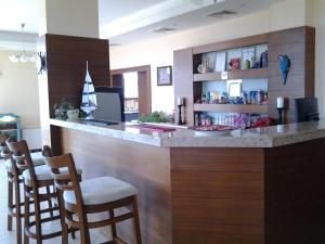 a bar with a counter with chairs in a room at Guest House Golden Flake 4km from Bolata beach in Bŭlgarevo