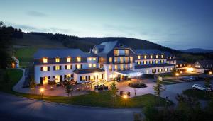 an aerial view of a large building with lights at Hotel Rimberg in Schmallenberg
